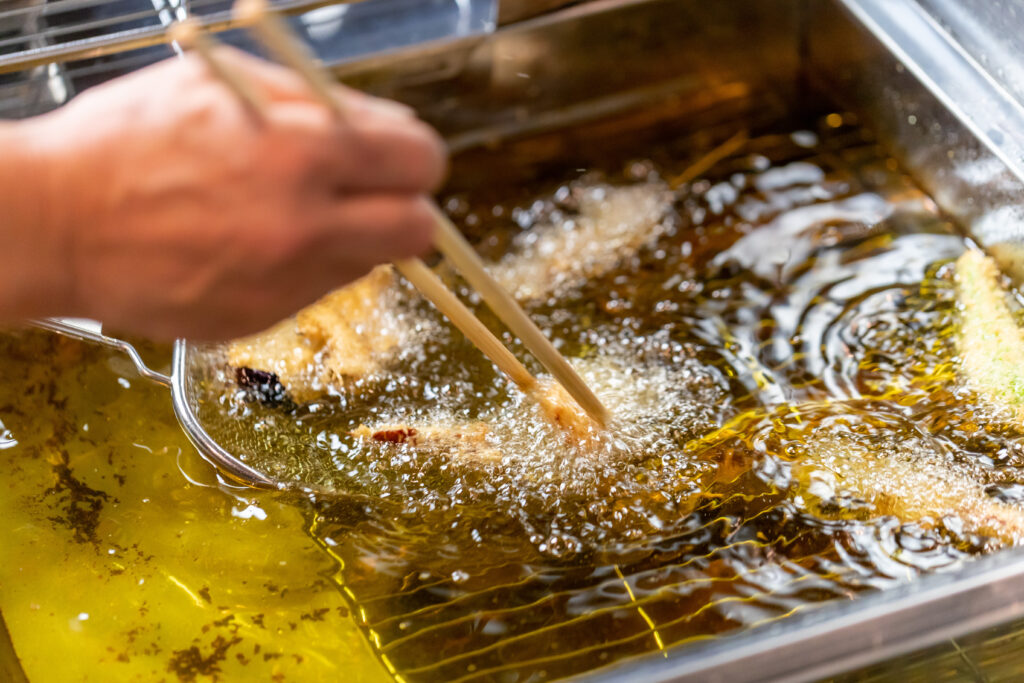 揚げ物を菜箸で上げているところ